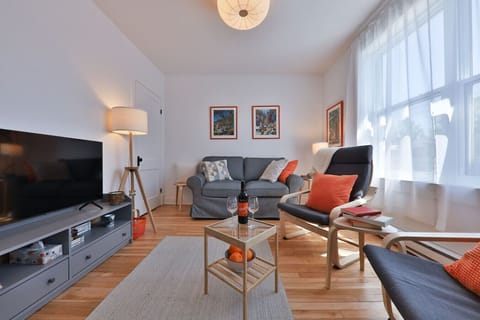 Bright living room with TV, Netflix & board games. #Airbnb
