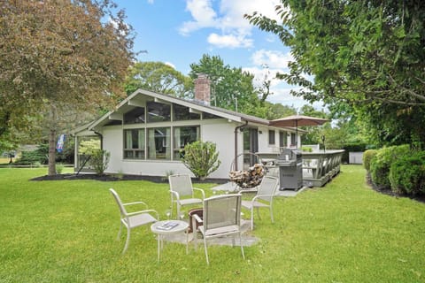 Rear yard with lawn seating, grill, and full house view