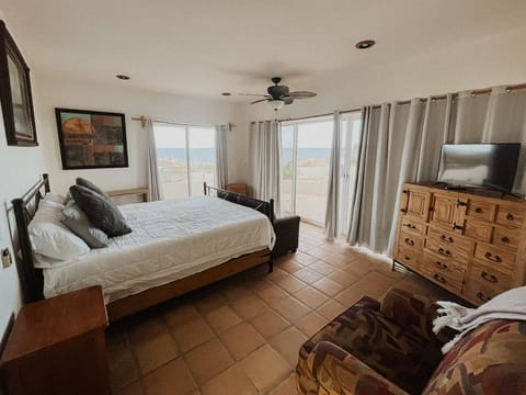 Primary bedroom with king bed, fans, TV, storage and a view