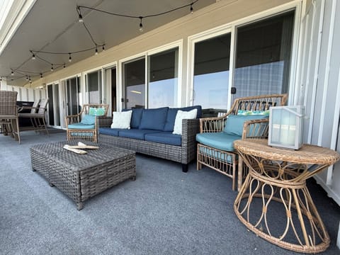 Deck with seating, outdoor table for eating, gas grill.