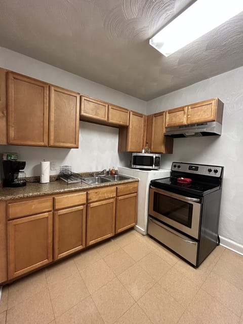 Full size kitchen with stainless steel appliances.