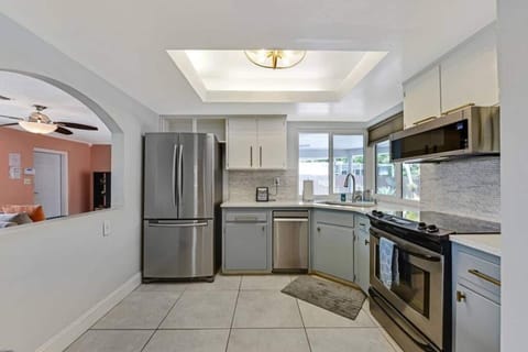 The kitchen is stocked with a full set of appliances including a refrigerator and basic kitchen utensils. 