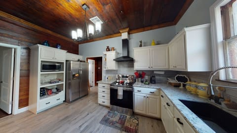 Another Kitchen view with refrigerator and microwave.