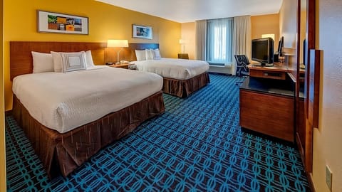 Unwind on plush beds in a bright, spacious room.