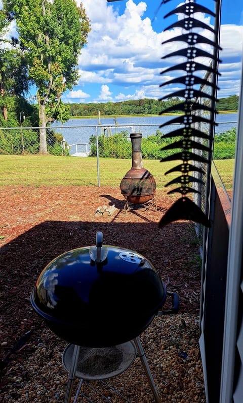Fenced area for grilling, frying fish. Table for 4 w/umbrella overlooking lake