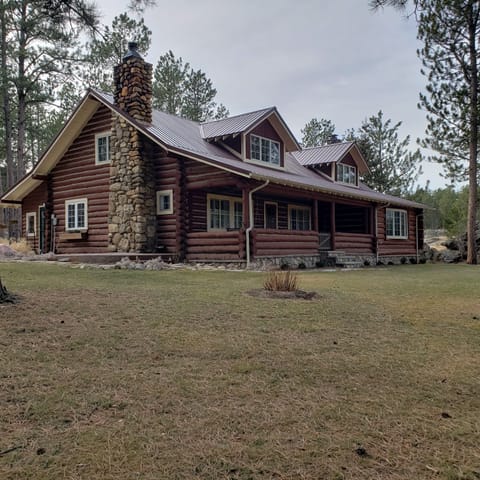 A covered porch with a swing includes views of the needles area.  