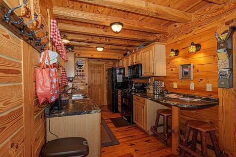 This open kitchen includes rustic cabinetry and charming seasonal touches, ideal for preparing meals after outdoor mountain adventures.