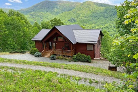 Smoky Mountain High in Bryson City sits perched on the hillside with dramatic long-range Smoky Mountain views, blending rustic charm with modern comfort.