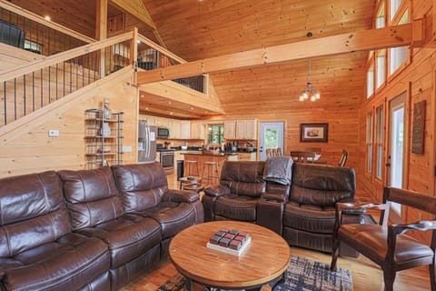 Cozy living room with leather seating and vaulted wood ceilings, perfect for relaxing in the Smoky Mountains.