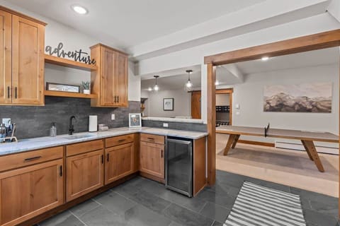 Enter through the basement door and be greeted by a wet bar and ping pong table.