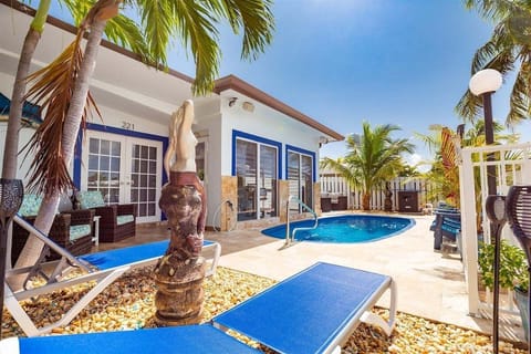 A private backyard oasis featuring a refreshing plunge pool, tropical landscaping, and seamless indoor-outdoor living.