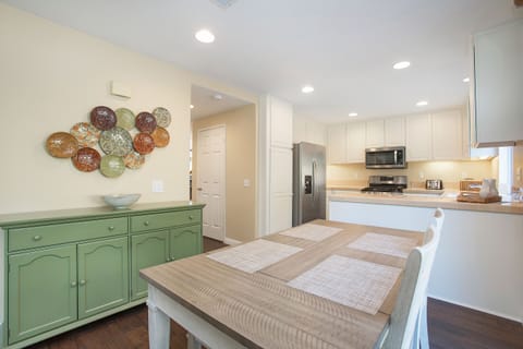 Gather for a meal or a board game in the sunlit dining area--table seats six.