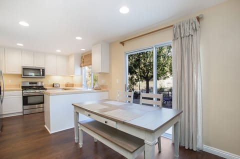 Gather for a meal or a board game in the sunlit dining area--table seats six.