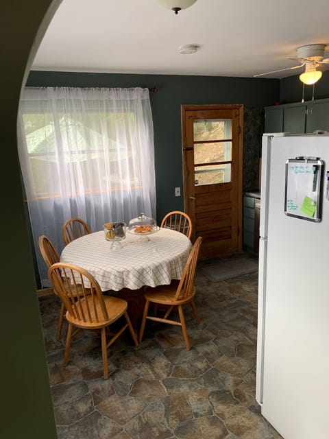 Eat in kitchen leads to back patio, firepit, and two outdoor tables