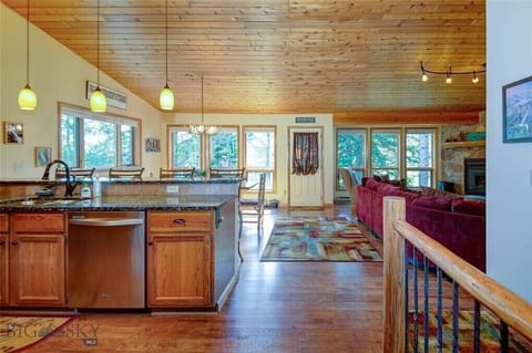 Large open concept living space with kitchen, dining and living room upstairs.
