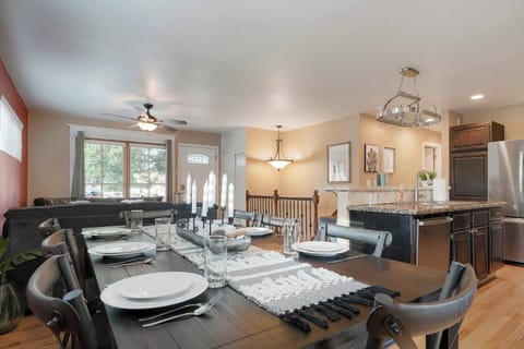 - Spacious dining area with a long table and stylish place settings for eight guests
- Open concept design allows conversation to flow from kitchen to living space
- Share meals, toast the day, or host game night at this central gathering spot