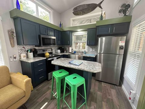 The dining area features a cozy counter with two bar stools—perfect for meals, morning coffee, or casual conversation.