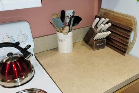 Sharp knives, lots of cooking utensils, cutting boards, tea kettle