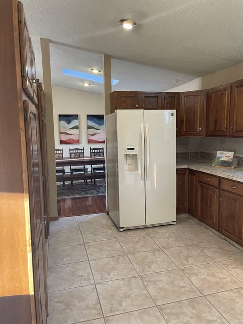 Kitchen area with ice machine in fridge and dining area off kitchen