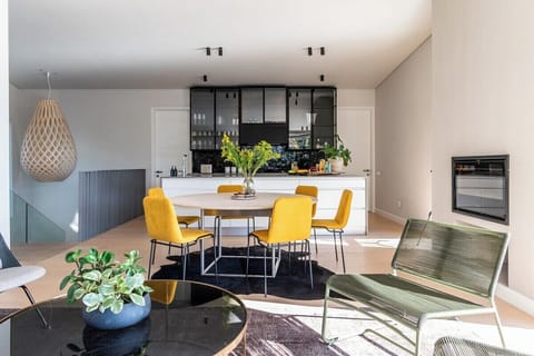 Upstairs dining with kitchen and fireplace