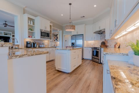 Large and open kitchen with stainless steel appliances and large island