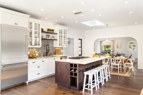 Spacious kitchen features a large island with barstool seats and state of the art applainces.