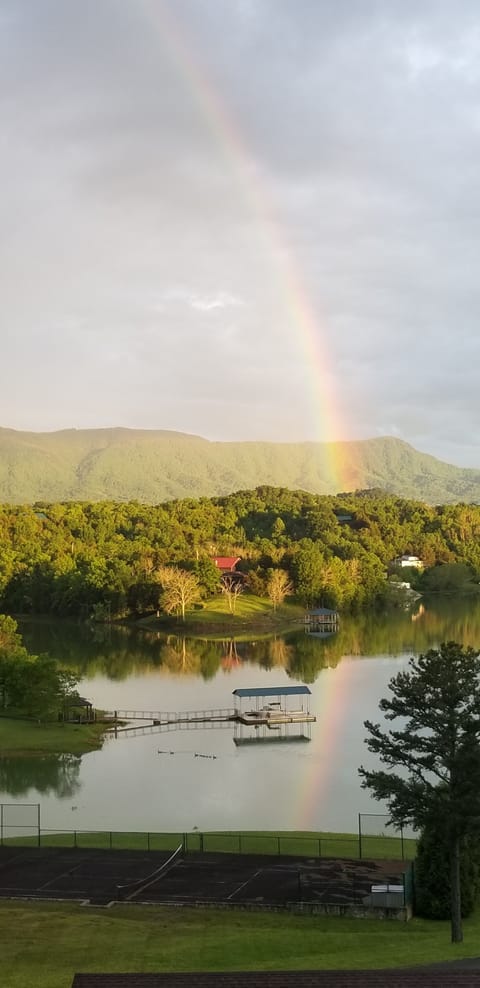 Rainbow highlighting mountain and lake views from private suite covered deck