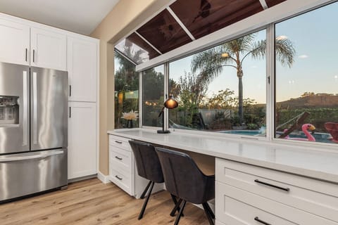 A study table next to the window with pool and canyon view.