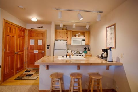 Kitchen, breakfast bar, and entryway.