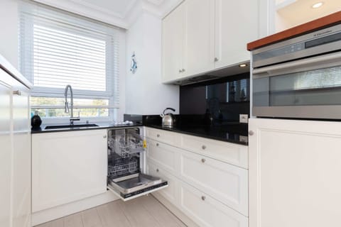 Another angle of the kitchen, showcasing modern appliances and a practical layout for cooking.