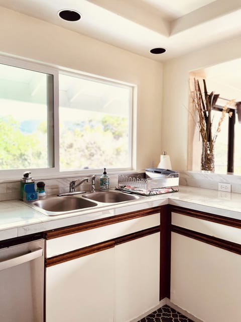Kitchen fully stocked with cooking essentials and utensils.