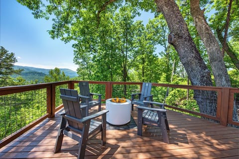 Gather around the fire pit on your private deck, sip morning coffee as sunlight filters through the trees, and take in sweeping mountain views from your peaceful treetop retreat.