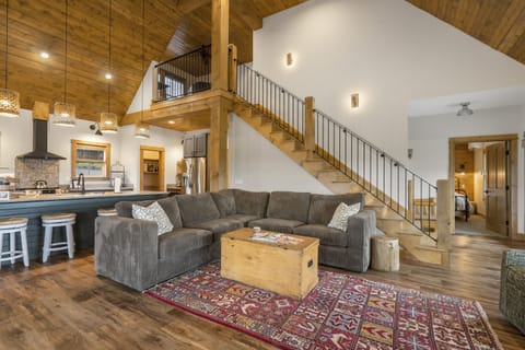 Living room area stairs lead to loft