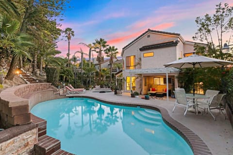 Large private swimming pool with outdoor seating.