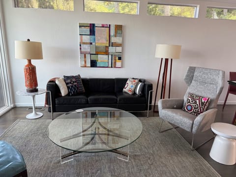 Living room with recliner chair faces the TV and the Bay view.
