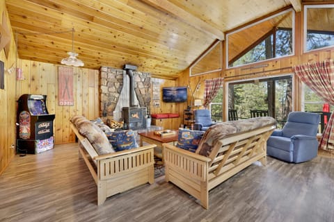 Spacious living room with cozy seating and warm décor, inviting guests to relax, gather, and enjoy memorable evenings together.