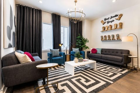 Relax and unwind in a bright living room with comfy gray sofas and vibrant blue chairs.