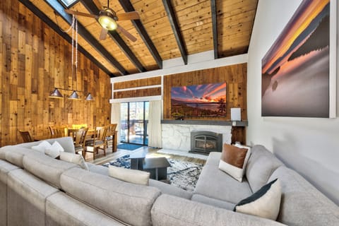 Sink into plush sofas by your crackling fireplace, where vaulted wood ceilings and mountain views create the perfect alpine retreat.