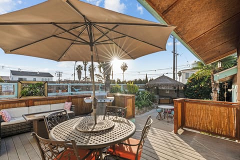 Large deck with seating, firepit table, propane BBQ.