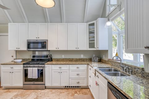 The light and airy kitchen is well stocked.