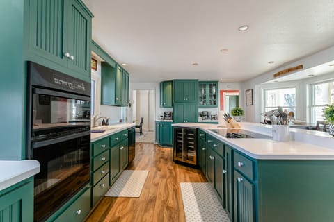 Built in microwave, oven, and electric glass cooktop for cooking.