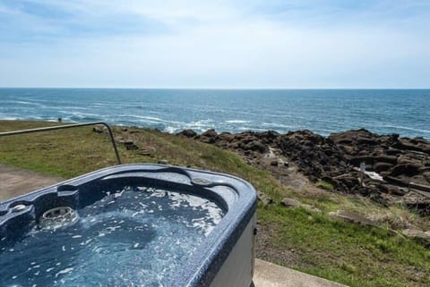 Soak in the hot tub while gazing out at sweeping ocean views