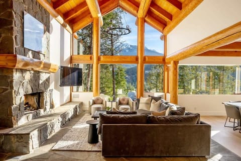 Unwind in the cozy living area, surrounded by breathtaking mountain views