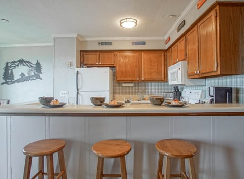 The kitchen bar has seating for 3.