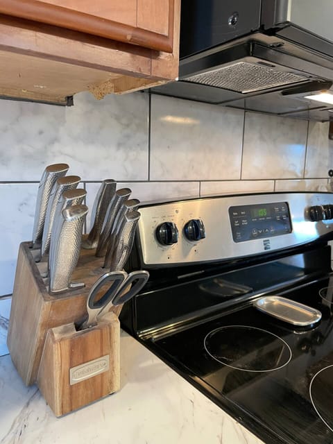 Fully stocked with pots, pans, cooking utensils, knives, and cutting boards