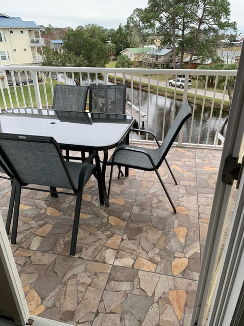 Covered tiled balcony patio with view of boat slip.