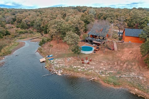Backyard with above ground pool and private fishing pond.