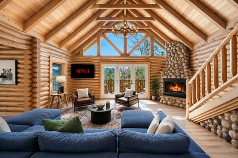 Our living room with cathedral ceilings, gorgeous views, and cozy fireplace.