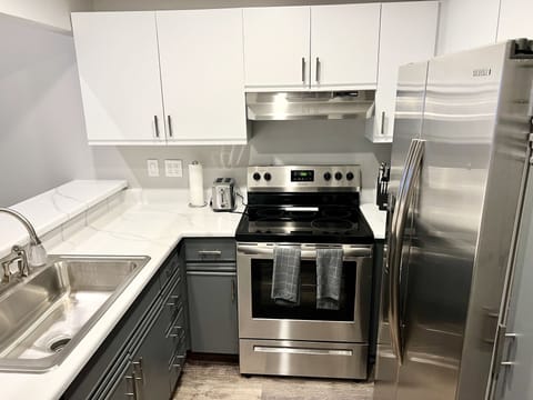 Kitchen with stainless appliances and bar seating for four