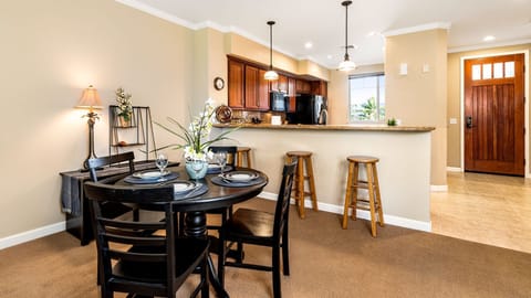 Inside dining area, kitchen and condo entrance *New dining table as of March 2022- Not Pictured